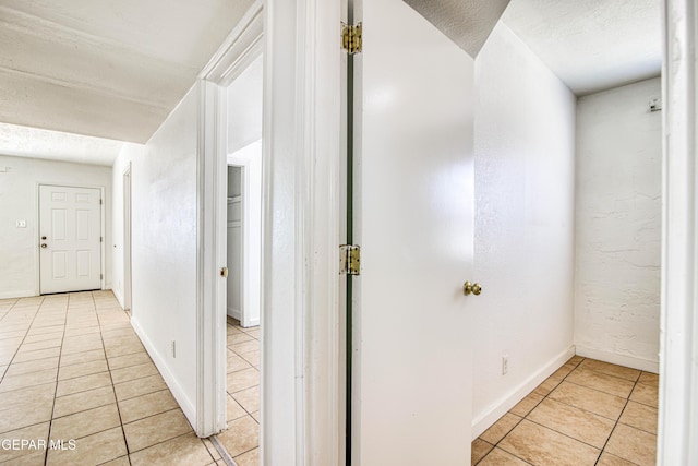 8929 Robert Dr Unit 1 & 2, El Paso, TX 79904 - hallway with baseboards, a textured ceiling, and light tile patterned floors