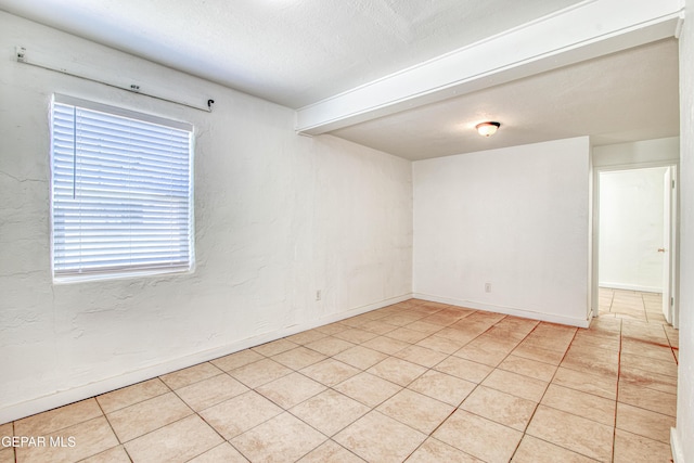 8929 Robert Dr Unit 1 & 2, El Paso, TX 79904 - empty room with baseboards, a textured ceiling, and light tile patterned floors