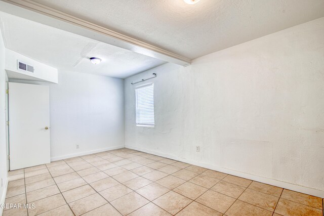 8929 Robert Dr Unit 1 & 2, El Paso, TX 79904 - empty room featuring baseboards, a textured ceiling, visible vents, and light tile patterned floors