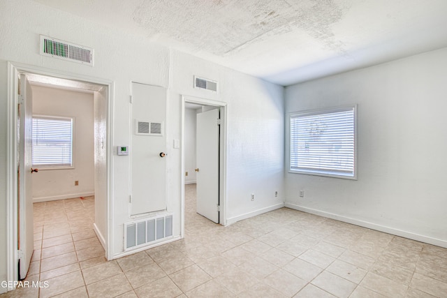 8929 Robert Dr Unit 1 & 2, El Paso, TX 79904 - spare room featuring light tile patterned flooring and visible vents