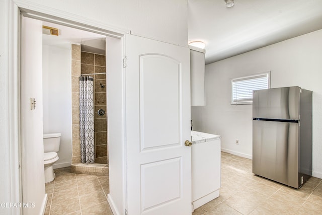 8929 Robert Dr Unit 1 & 2, El Paso, TX 79904 - bathroom with toilet, tile patterned floors, a shower stall, and baseboards