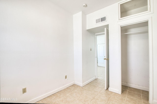 8929 Robert Dr Unit 1 & 2, El Paso, TX 79904 - unfurnished bedroom featuring baseboards, a closet, light tile patterned flooring, and visible vents