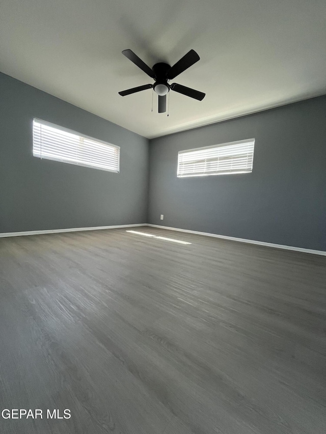 unfurnished room featuring a ceiling fan, baseboards, and a healthy amount of sunlight