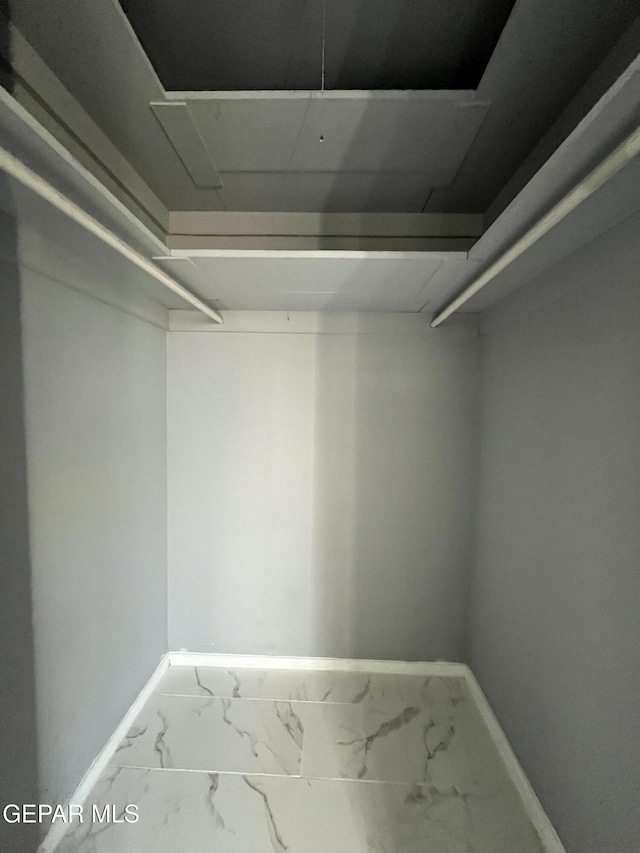 spacious closet with marble finish floor