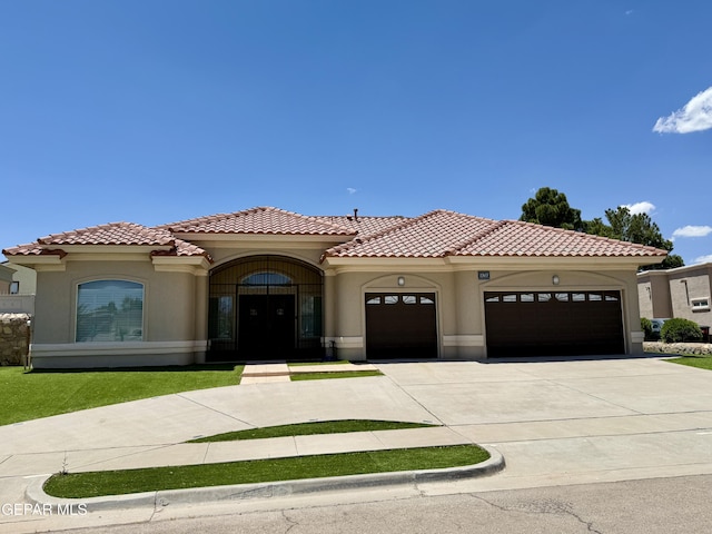 1363 Golden Trail Ln, El Paso, TX 79936 - mediterranean / spanish house with stucco siding, a garage, driveway, and a tile roof