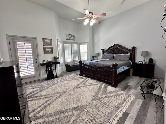 1363 Golden Trail Ln, El Paso, TX 79936 - bedroom featuring a towering ceiling, wood finished floors, multiple windows, baseboards, and ceiling fan