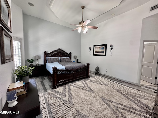 1363 Golden Trail Ln, El Paso, TX 79936 - bedroom featuring wood finished floors, a ceiling fan, and a high ceiling