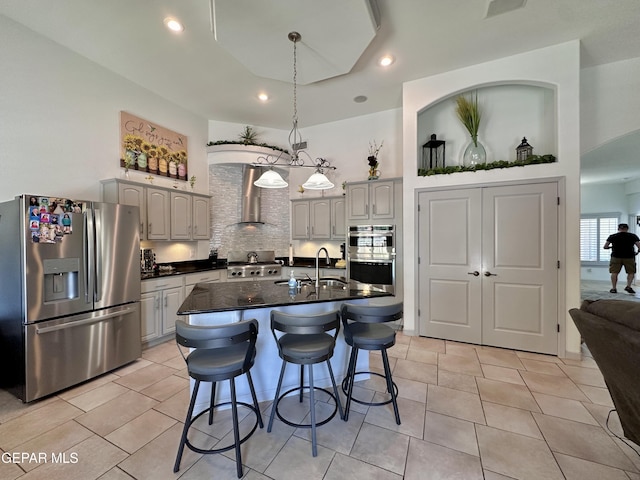 1363 Golden Trail Ln, El Paso, TX 79936 - kitchen featuring appliances with stainless steel finishes, a sink, wall chimney exhaust hood, a breakfast bar area, and backsplash