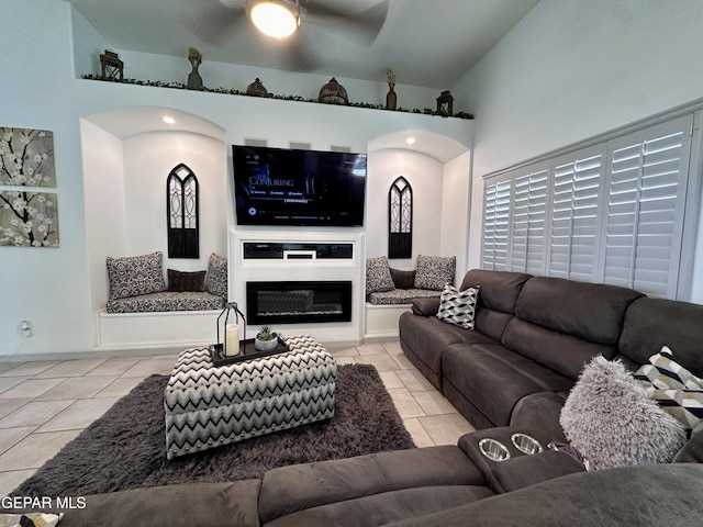 1363 Golden Trail Ln, El Paso, TX 79936 - living room with tile patterned floors, ceiling fan, arched walkways, and a glass covered fireplace