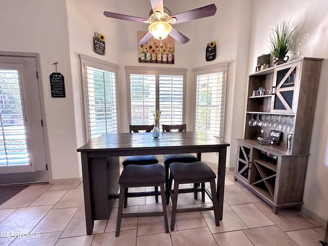 1363 Golden Trail Ln, El Paso, TX 79936 - dining area with ceiling fan, light tile patterned floors, a towering ceiling, and baseboards