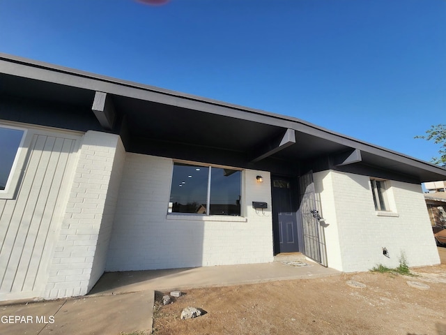 property entrance with brick siding