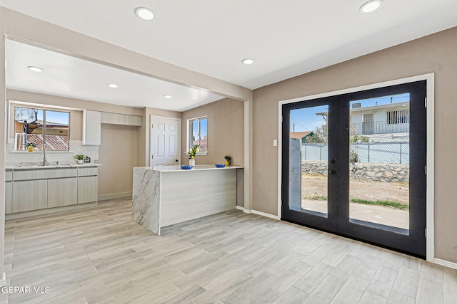 7113 Pear Tree Ln, El Paso, TX 79915 - kitchen with a sink, baseboards, french doors, a peninsula, and recessed lighting