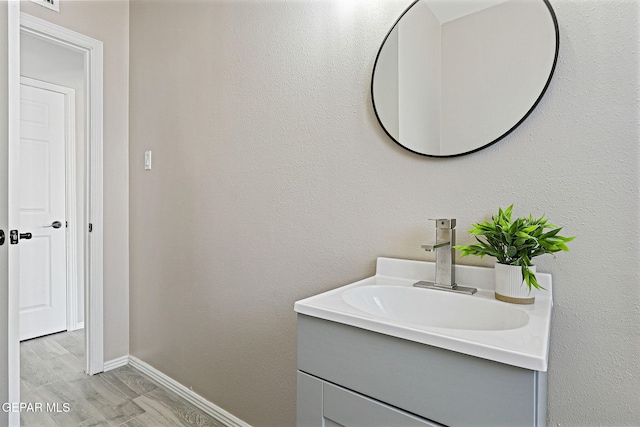 7113 Pear Tree Ln, El Paso, TX 79915 - bathroom featuring vanity, baseboards, and wood finished floors