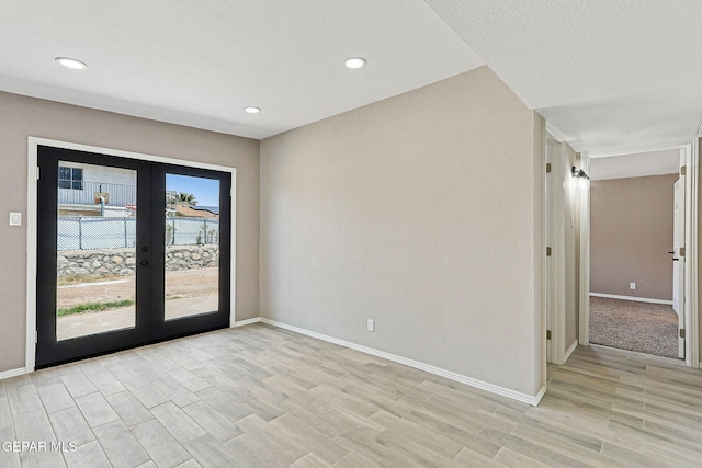 7113 Pear Tree Ln, El Paso, TX 79915 - unfurnished room featuring baseboards, french doors, light wood-type flooring, and recessed lighting