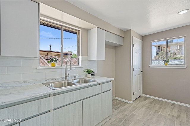 7113 Pear Tree Ln, El Paso, TX 79915 - kitchen featuring a sink, decorative backsplash, and plenty of natural light