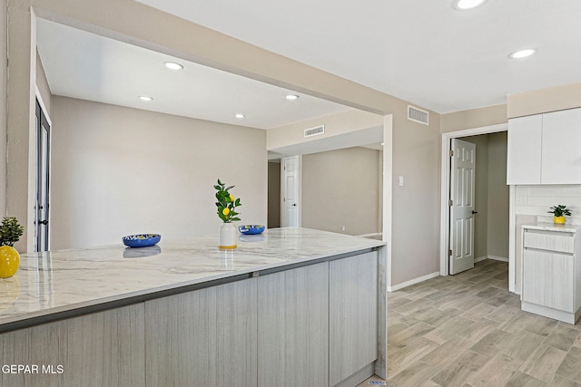 7113 Pear Tree Ln, El Paso, TX 79915 - kitchen with recessed lighting, baseboards, light stone countertops, white cabinetry, and modern cabinets