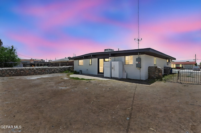 7113 Pear Tree Ln, El Paso, TX 79915 - back of property at dusk with a patio