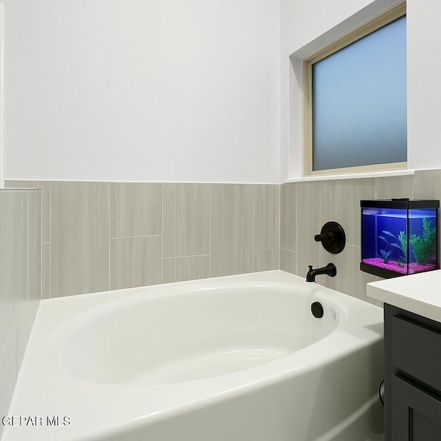 bathroom featuring vanity and a garden tub