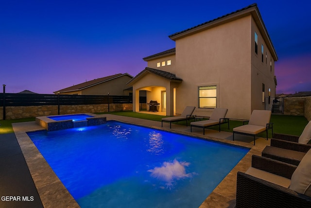pool at dusk with a fenced backyard, a pool with connected hot tub, a patio area, and a grill
