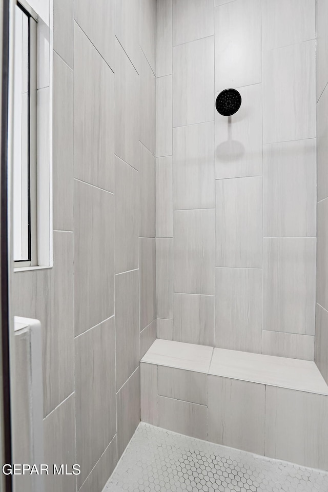 full bath featuring tiled shower
