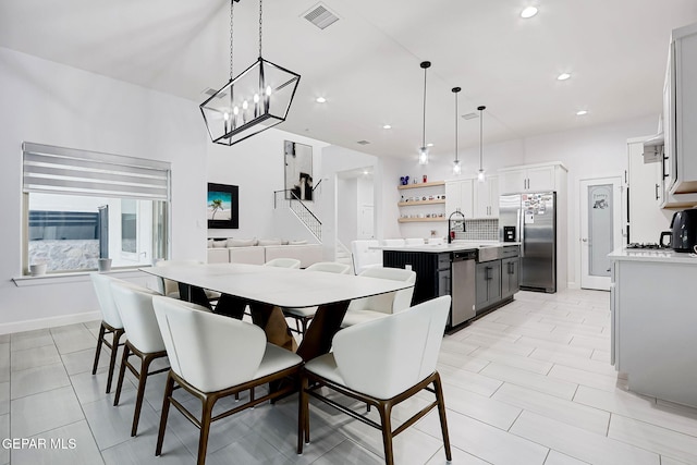 dining space with baseboards, recessed lighting, a chandelier, and visible vents