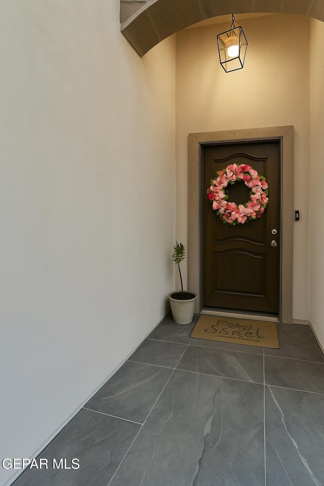 doorway to property featuring stucco siding