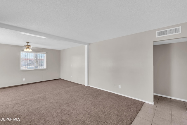 10601 Teresa Pl, El Paso, TX 79924 - spare room with a ceiling fan, a textured ceiling, tile patterned floors, and baseboards