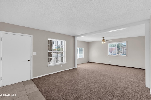 10601 Teresa Pl, El Paso, TX 79924 - tiled spare room with a ceiling fan, a textured ceiling, carpet, and baseboards