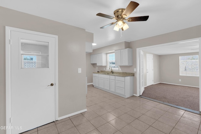 10601 Teresa Pl, El Paso, TX 79924 - kitchen featuring baseboards, light countertops, white cabinetry, a ceiling fan, and a sink