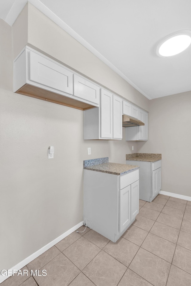 10601 Teresa Pl, El Paso, TX 79924 - kitchen featuring light tile patterned floors, white cabinets, and baseboards