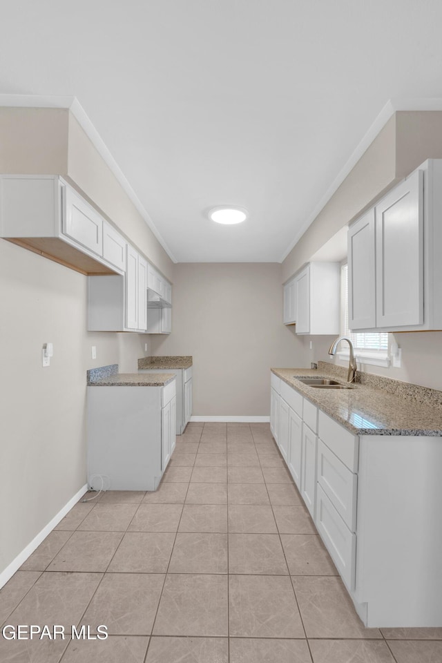 10601 Teresa Pl, El Paso, TX 79924 - kitchen with a sink, baseboards, ornamental molding, white cabinetry, and light tile patterned flooring