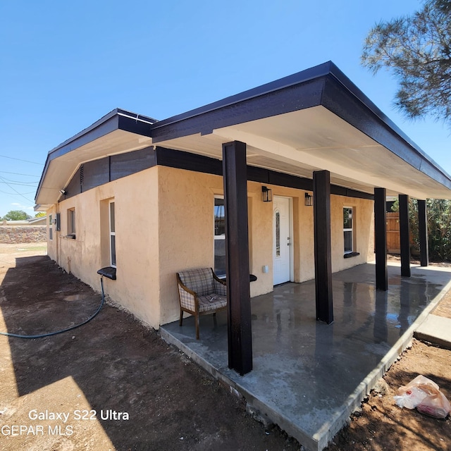 view of front facade featuring a patio and stucco siding