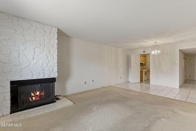 4800 N Stanton St Unit 87, El Paso, TX 79902 - unfurnished living room featuring a large fireplace, light tile patterned floors, a chandelier, and light colored carpet