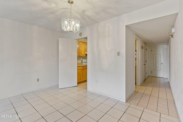 4800 N Stanton St Unit 87, El Paso, TX 79902 - unfurnished room featuring a textured ceiling, a notable chandelier, and light tile patterned floors