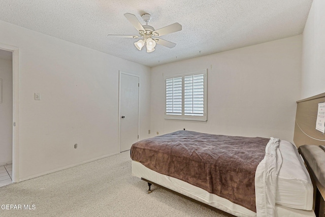 4800 N Stanton St Unit 87, El Paso, TX 79902 - bedroom with a textured ceiling, a ceiling fan, and carpet