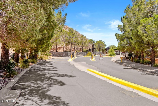 4800 N Stanton St Unit 87, El Paso, TX 79902 - view of street featuring a gated entry, curbs, and sidewalks