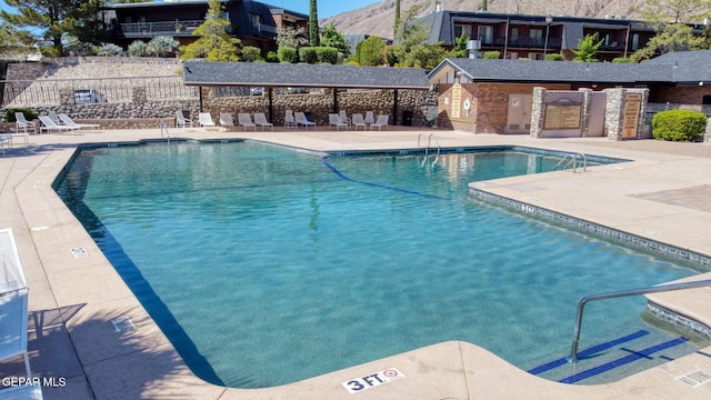4800 N Stanton St Unit 87, El Paso, TX 79902 - pool featuring fence, a mountain view, and a patio area