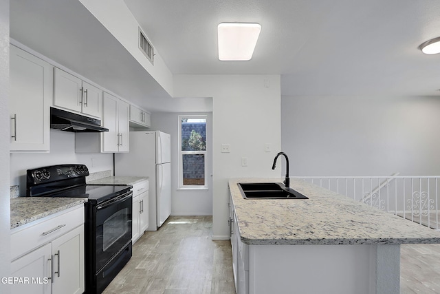 kitchen with a sink, light wood-style flooring, under cabinet range hood, visible vents, and black range with electric stovetop