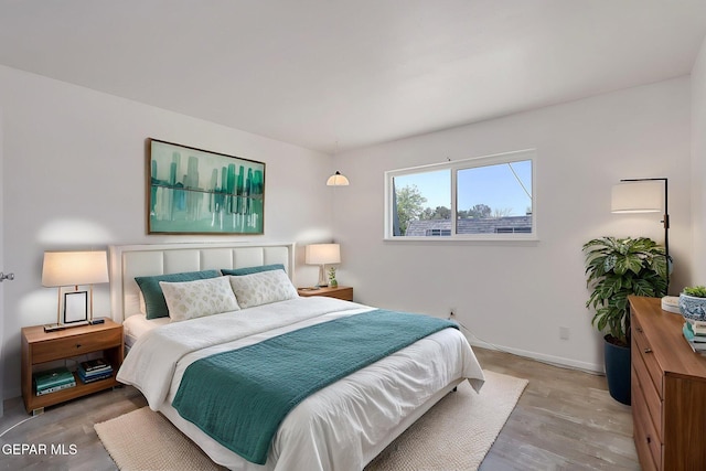 bedroom with baseboards and wood finished floors