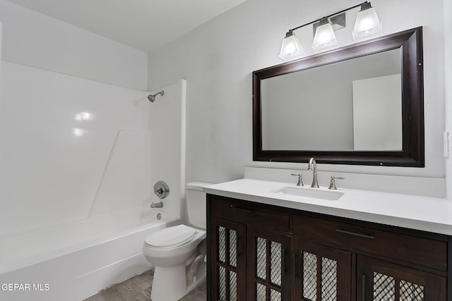 full bathroom featuring vanity, shower / bathtub combination, wood finished floors, and toilet