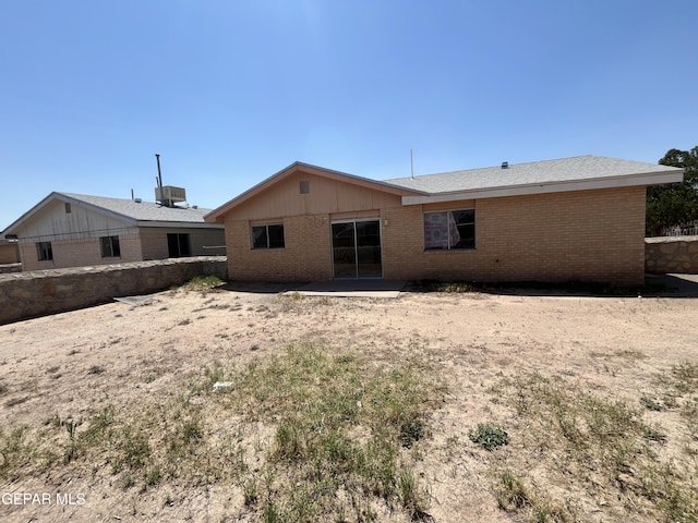 rear view of property featuring central air condition unit, brick siding, and a patio