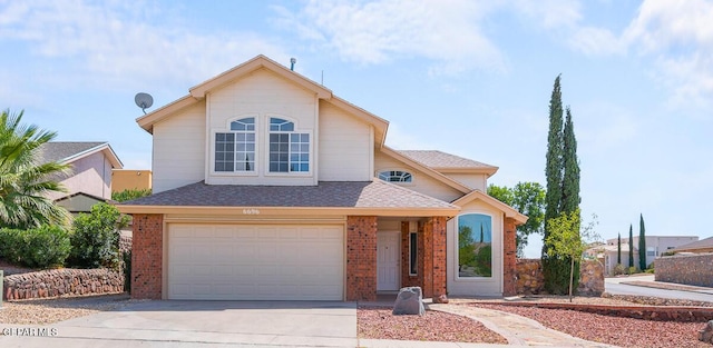 traditional home featuring an attached garage, a shingled roof, brick siding, and concrete driveway