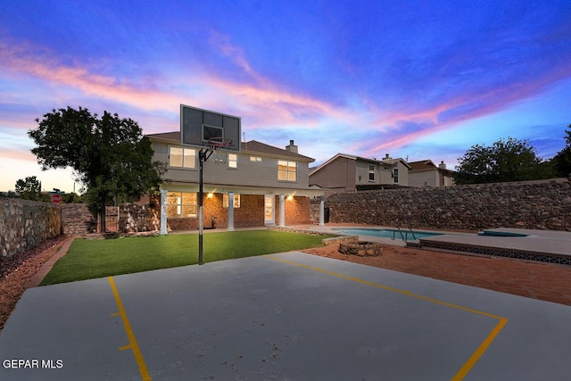 traditional home with a fenced in pool, a fenced backyard, a front yard, and a patio area