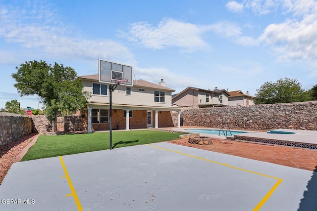 view of basketball court with a lawn, a fenced in pool, and a fenced backyard