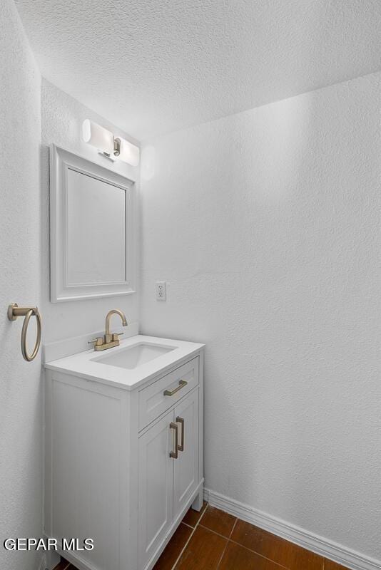 bathroom with vanity and a textured ceiling