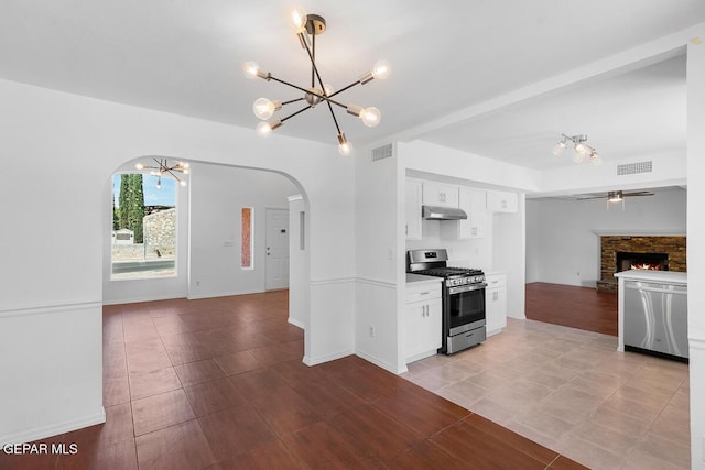 kitchen featuring appliances with stainless steel finishes, visible vents, arched walkways, and open floor plan