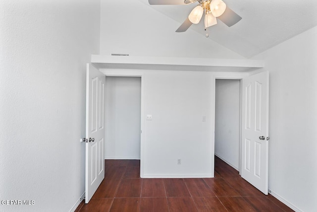 unfurnished bedroom featuring visible vents, wood finished floors, baseboards, ceiling fan, and vaulted ceiling