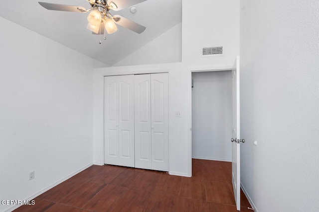 unfurnished bedroom with baseboards, dark wood finished floors, high vaulted ceiling, and visible vents