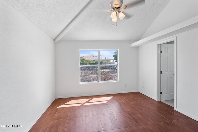 empty room featuring ceiling fan, a textured ceiling, vaulted ceiling, wood finished floors, and baseboards
