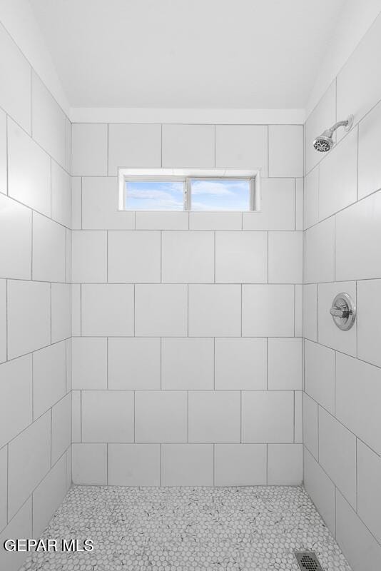 bathroom with tiled shower